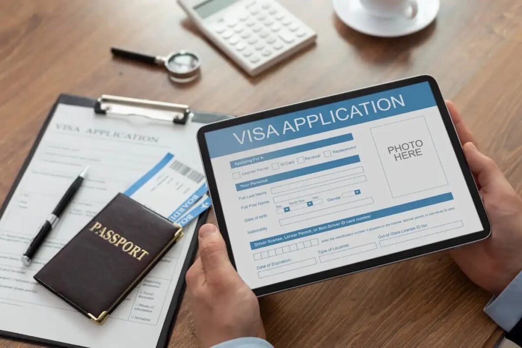 A visa application form on a tablet next to a passport